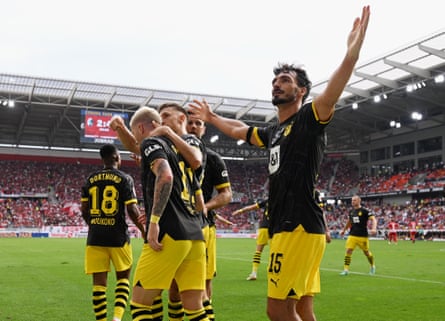 Borussia Dortmund players celebrate after Marco Reus scored their fourth goal in the 4-2 win at Freiburg.