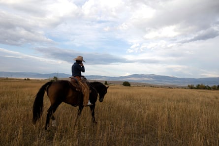 Savannah McCarty pauses while riding one of her horses on her property