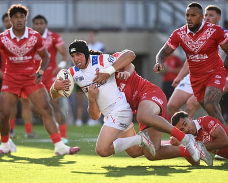 Victor Radley is tackled by Jason Taumalolo in the Rugby League World Cup match between England and Tonga