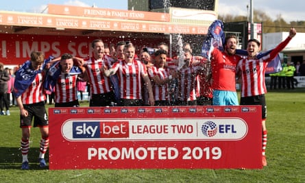 Lincoln players celebrate their promotion.