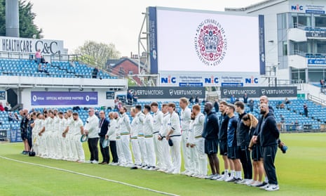 Yorkshire and Glamorgan players stand for the national anthem at Headingley.