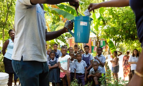 School children near Mirebalais are shown how to mix oral rehydration solution as part of an effort to target any possible cases of cholera in Haiti before they can spread
