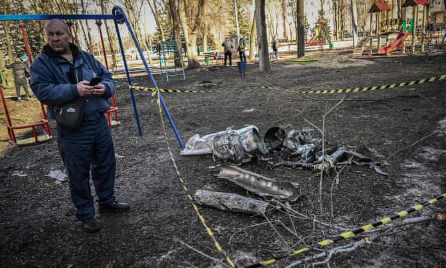 Man next to fragments of missile