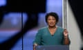 Georgia Democratic gubernatorial candidate Stacey Abrams participates in a debate with Stacey Evans as a stage manager holds up a time card Sunday, May 20, 2018, in Atlanta. (AP Photo/John Amis)