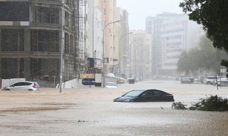 Abandoned cars on a flooded street in Muscat, Oman, on Sunday.