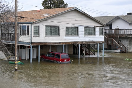 Buildings and vehicles are partially submerged after levee fails in Manteca of San Joaquin county, on Tuesday.