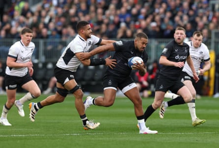 Bath's Ollie Lawrence bursts through a tackle