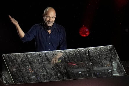 DJ Etienne de Crecy performs in the rain.