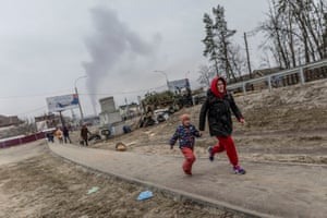 Russia-Ukraine war: Zelenskiy vows to ‘punish atrocities’ as family dies trying to evacuate Irpin – live | World news 3 Residents run for cover as they escape from Irpin after heavy shelling on the only escape route used by locals.
