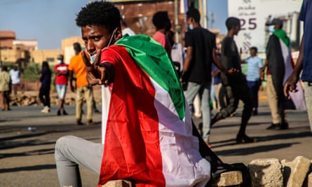 A Sudanese protester flashes the victory sign.