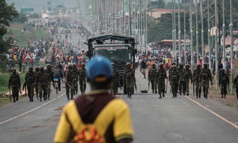 Police officers patrolling a barricaded road during a protest in 2017.