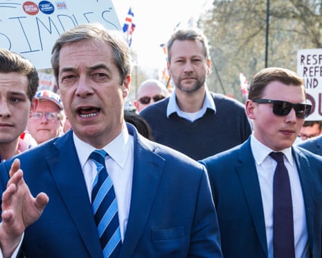 Nigel Farage and George Cottrell walking in a crowd