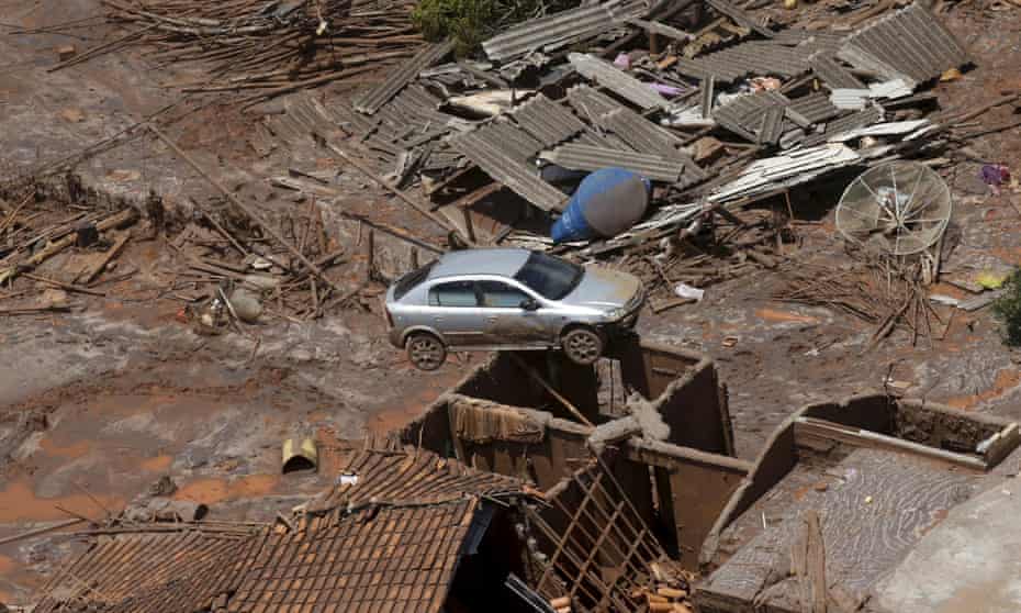 A car sits atop a roof covered in mud and other debris after the collapse of a tailings dam in Brazil.