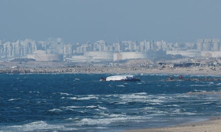 A ship carrying aid moves towards the shore as Gaza can be seen in the distance