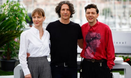 The Zone of Interest director Jonathan Glazer with cast members Sandra Hüller and Christian Friedel at Cannes 2023.