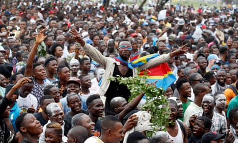 Felix Tshisekedi’s supporters celebrate outside the party’s headquarters in Kinshasa.