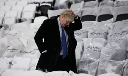 Boris Johnson walks past seats after an official switching on ceremony of the floodlights at the London 2012 Olympic stadium in 2010.