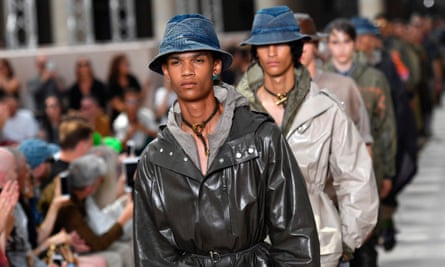 Models in Louis Vuitton trenchcoats.