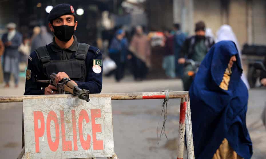 A Pakistani security official stands guard outside a church in Peshawar on 31 January. 