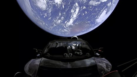 SpaceX shows the company’s spacesuit in Elon Musk’s red Tesla sports car