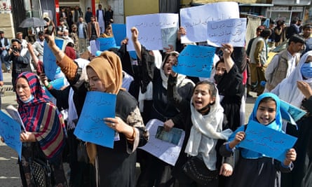Afghan women and girls take part in a protest in front of the Ministry of Education in Kabul in March, demanding that high schools be reopened for girls.