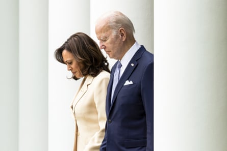 A woman and a man next to white columns.