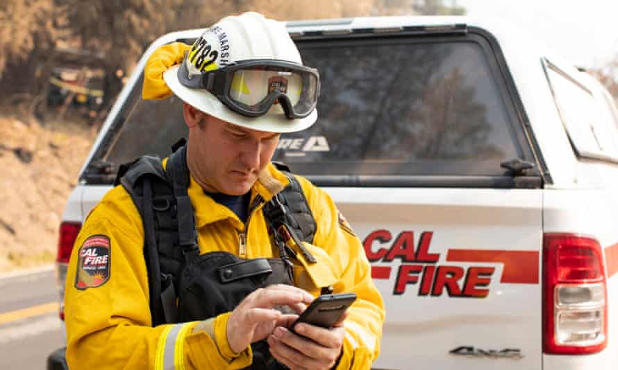 Joseph Gibson, deputy state fire marshal, adds destruction details to a Cal Fire app on Saturday after inspecting a structure hit by the Dixie fire.