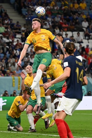Harry Souttar heads the ball away from danger in the Socceroos box.
