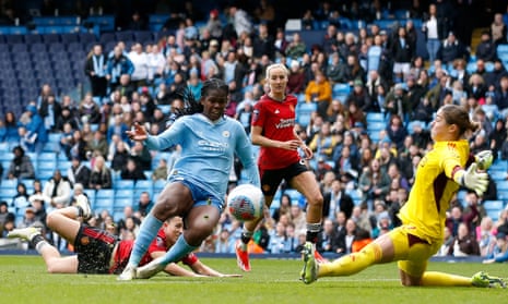 Manchester City's Khadija Shaw scores their third goal past Manchester United's keeper Mary Earps.