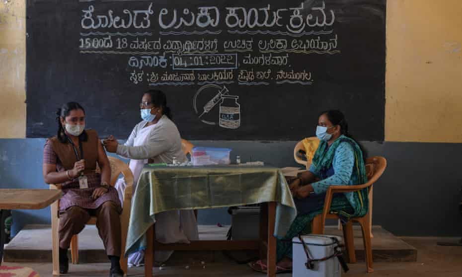 A health worker inoculates a student with a dose of the Covaxin vaccine against the Covid-19 coronavirus during a vaccination drive for youths of the 15-18 group age at a Government High School in Bangalore.