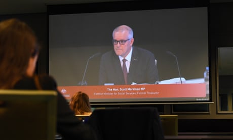 Former prime minister Scott Morrison is seen on a screen in the media room at the first hearing block of the Royal Commission into the Robodebt Scheme at the Pullman Brisbane King George Square Hotel in Brisbane, Wednesday, December 14, 2022. (AAP Image/Jono Searle) NO ARCHIVING
