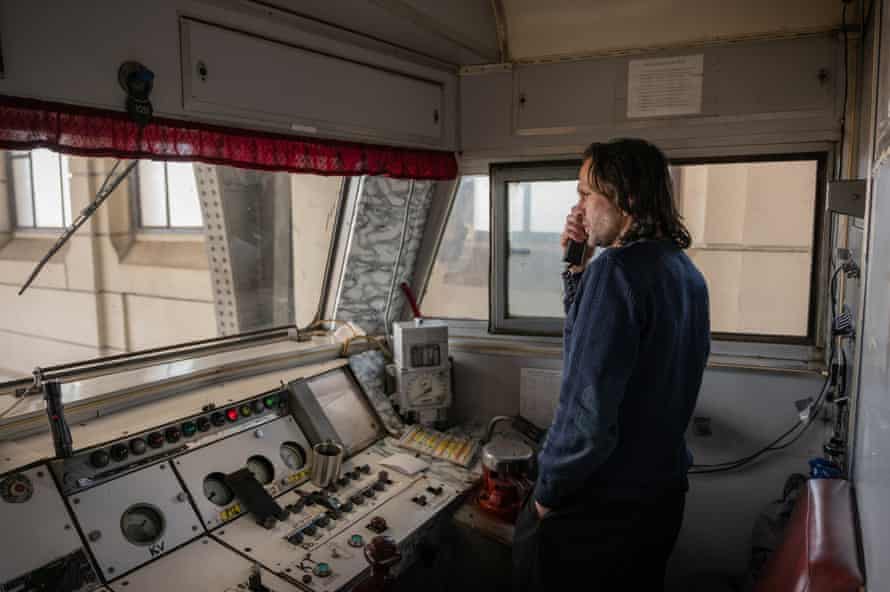 Evacuation train driver Eugen Zagoruk gets the final call with permission to leave the station for Poland with a full evacuation train
