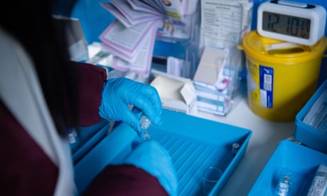 A nurse prepares Pfizer jabs to be administered at an NHS mobile vaccination centre
