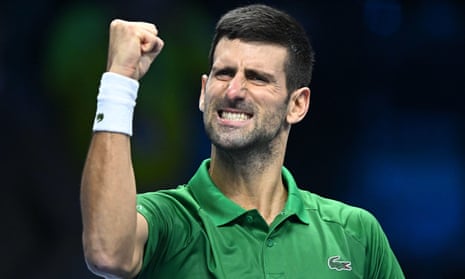 Novak Djokovic celebrates during a tennis match. He is pumping his fist and baring his clenched teeth