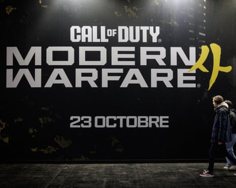 Visitors walks past a Call Of Duty Modern Warfare 4 placard. The gameâÂÂs maker has been accused of using footage of the 2022 Seoul crowd crush in the game.