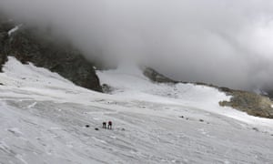 Police investigate t he site where the body of a German hiker was found in the Valais canton near Saas-Fee, Switzerland.