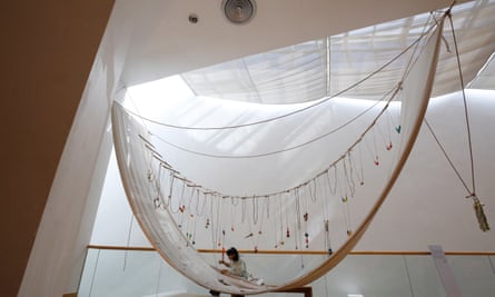 A Stitch in Time by David Medalla, in which visitors were asked to sew cotton stitches (or anything else it liked) on to a skein of fabric hanging from a gallery ceiling, as seen at an exhibition in Bangkok, Thailand, in 2019.