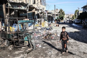 Idlib, Syria. A child walks past the damage in a marketplace in the rural town of Ariha