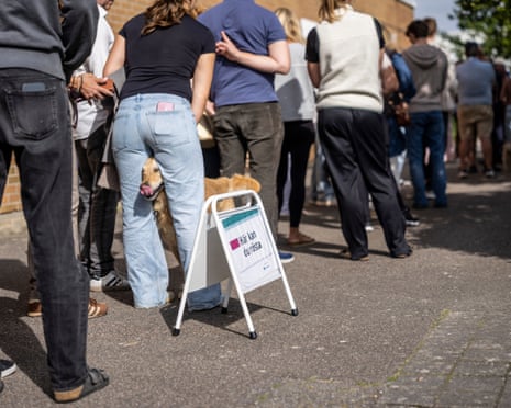 Voters queue to cast ballots at a polling station in a sports hall during Sweden's general election in Lomma, southern Sweden.