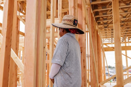 a man in a hat working on a construction site stands for a portrait with his back turned
