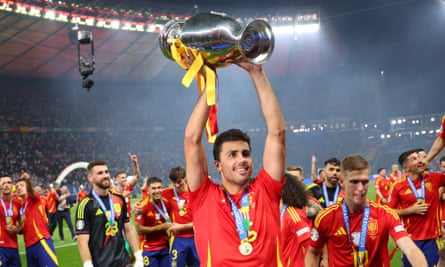 Rodri lifts the European Championship trophy in celebration after Spain’s victory in the final.