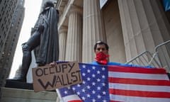 Occupy Wall Street Protesters in The Free Speech Zone on the Steps of the Federal Hall National Memorial<br>30 Apr 2012, Manhattan, New York City, New York State, USA --- New York City, NY, April 30th, An activist in the Occupy Wall Street movement holds an American flag on the steps of Federal Hall National Memorial that has become a gathering point for the Occupy Wall Street Movement. The Federal Parks police permit twenty five protesters at a time on the steps in an area deemed the free speech area, which all federal parks are by law required to allow. The Occupy Wall Street protesters refer to the 'free speech zone' as the 'freedom cage' --- Image by   Julie Dermansky/Julie Dermansky/Corbis