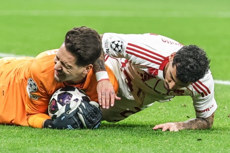 Bayer Leverkusen keeper Janis Blaswich (left) grimaces as he pounces on the ball ahead of Olympiacos' Chiquinho.