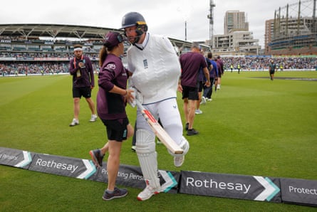 Chris Woakes of England walks off the pitch at the end of the game with his left arm in a sling after dislocating his shoulder.