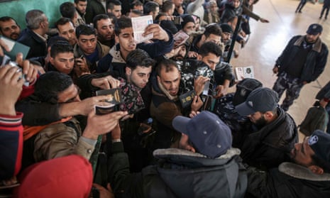 Palestinians wait for travel permits to cross into Egypt through the Rafah border crossing.