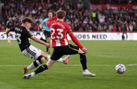 Victor Munoz shoots at goal as a Brentford defender slides in to block