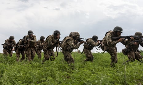 Ukrainian soldiers move in line as they take part in infantry training in Donetsk Oblast.
