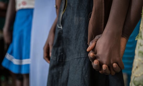 Girls hold hands at a ceremony to mark their release from armed groups in Yambio, south Sudan. 