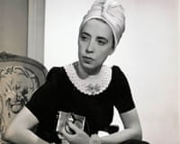 B/W 1940 photo of designer Elsa Schiaparelli wearing black silk dress with crocheted collar of her own design and a turban