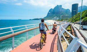 Cyclist and scooter share the newly completed Ciclovia Tim Maia bike path